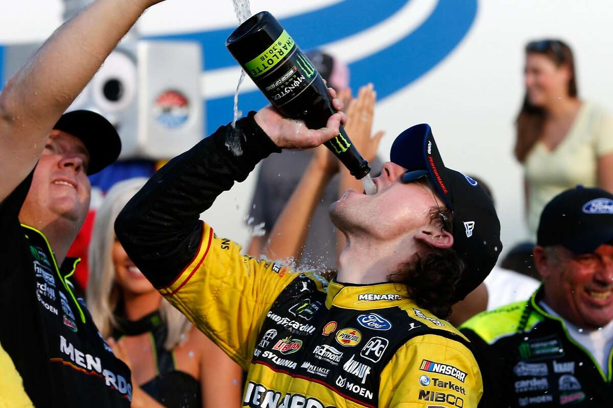 CHARLOTTE, NC - SEPTEMBER 30: Ryan Blaney, driver of the #12 Menards/Pennzoil Ford, celebrates in Victory Lane after winning the Monster Energy NASCAR Cup Series Bank of America Roval 400 at Charlotte Motor Speedway on September 30, 2018 in Charlotte, North Carolina. (Photo by Brian Lawdermilk/Getty Images)