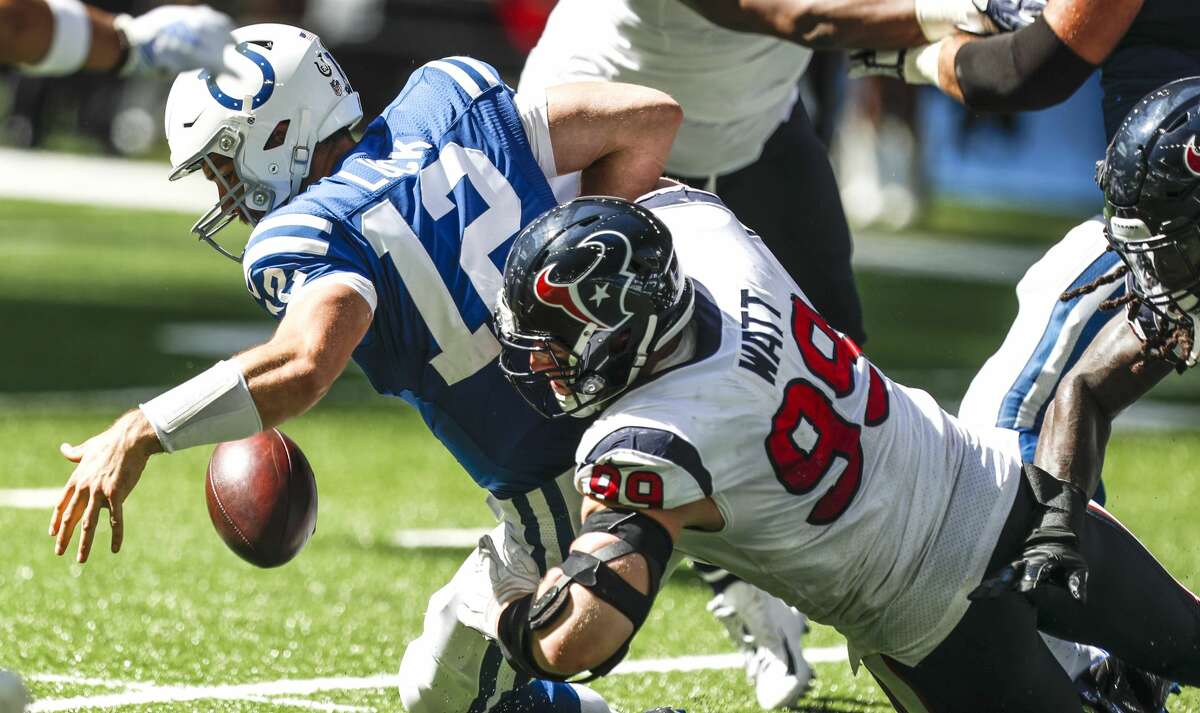 Houston Texans defensive end J.J. Watt (99) hits Indianapolis Colts quarterback Andrew Luck (12), forcing a fumble during the second quarter of an NFL football game at Lucas Oil Stadium on Sunday, Sept. 30, 2018, in Indianapolis.
