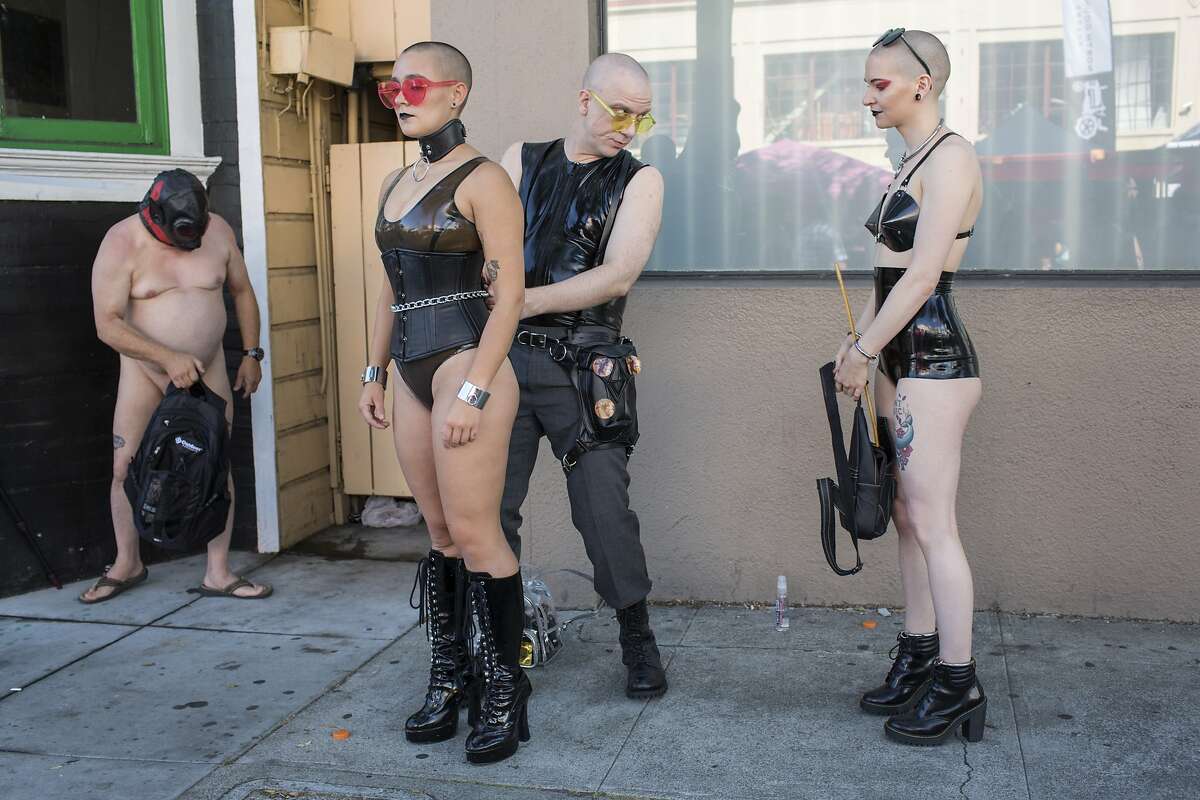 Mr. Torn (center) with Umile (left) and Zita (right) prepare to participate at the 35th annual Folsom Street Fair on Sunday, September 30, 2018 in San Francisco Calif.