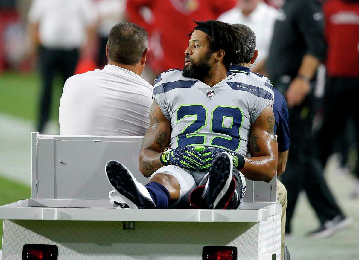 Seattle Seahawks defensive back Earl Thomas (29) leaves the field after breaking his leg against the Arizona Cardinals during the second half of an NFL football game, Sunday, Sept. 30, 2018, in Glendale, Ariz. The Seahawks won 20-17. (AP Photo/Ross D. Franklin)