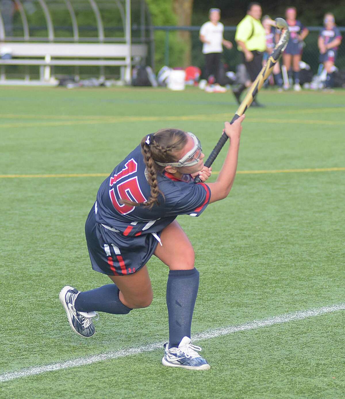 Greens Farms Academy field hockey player Lucy Holzinger rips off a drive during last week?’s game against Rye Country Day in Westport. The Dragons are off to a 4-1 start this season.