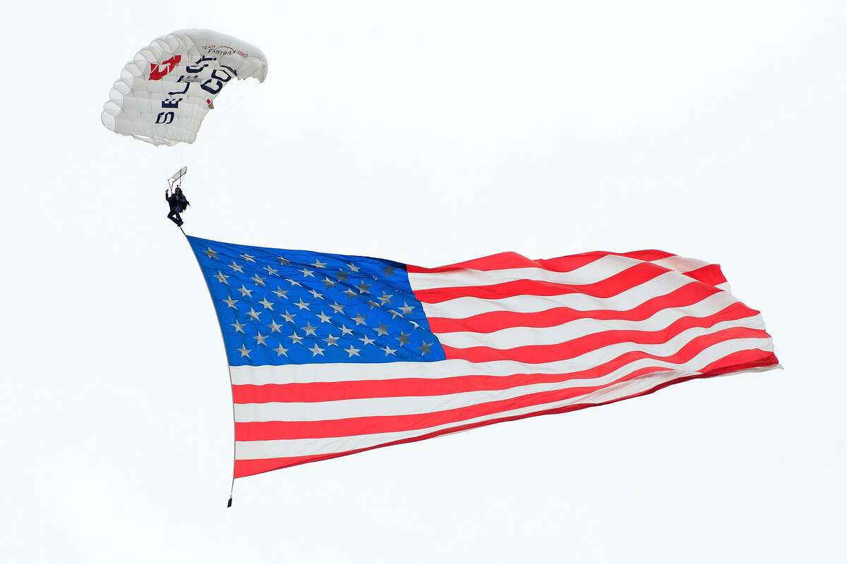 CINCINNATI, OH - SEPTEMBER 22: A skydiver glides down with the American Flag in the game between the Ohio Bobcats and the Cincinnati Bearcats at Nippert Stadium on September 22, 2018 in Cincinnati, Ohio. (Photo by Justin Casterline/Getty Images)