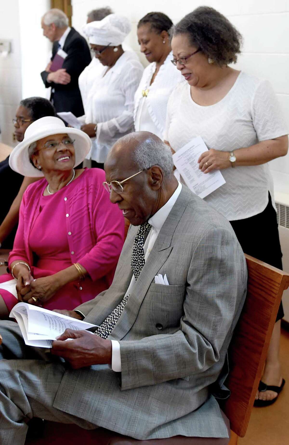 In this file photo, choir member Sharyn Esdaile, right, with Jan Parker, left, and her husband, former State Treasurer Henry Parker, during a church service at the Dixwell United Church of Christ in New Haven in 2015.