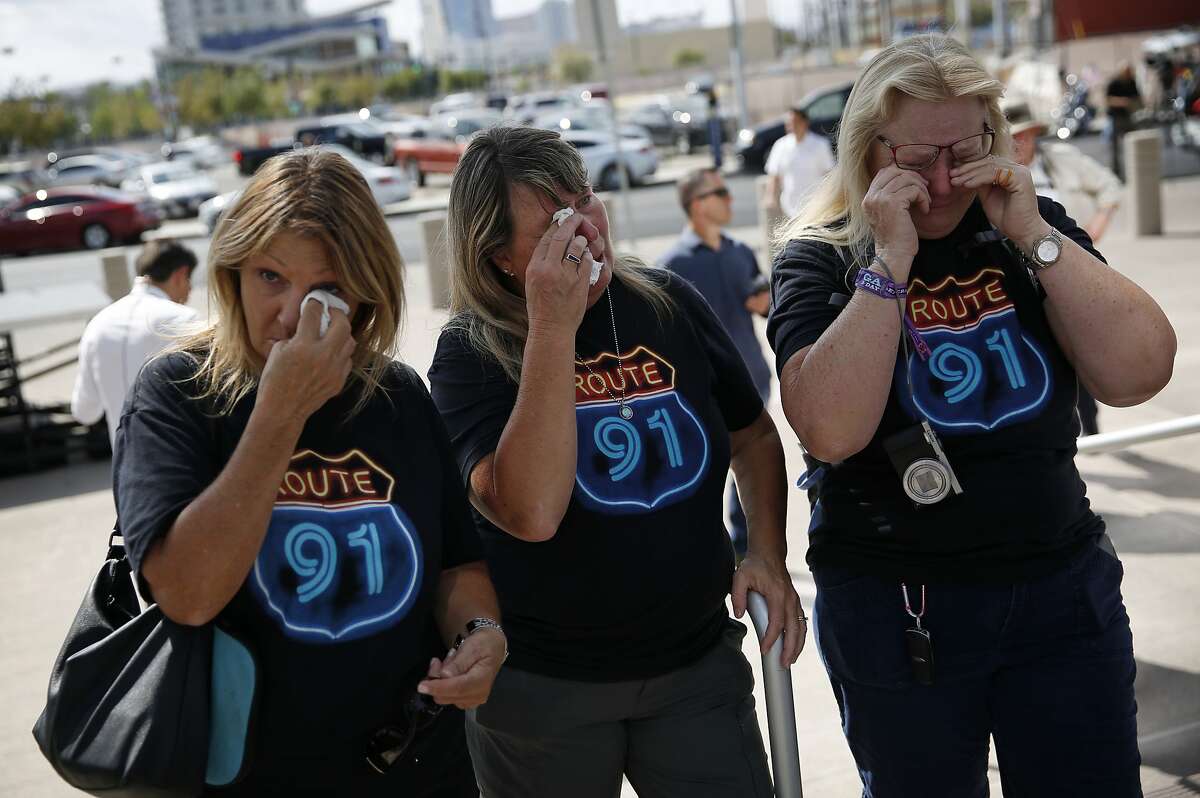 From left, Linda Hazelwood, Michelle Hamel and Jann Blake, all from California, cry as they attend a prayer service on the anniversary of the Oct. 1, 2017 mass shooting, Monday, Oct. 1, 2018, in Las Vegas. The three saw bullets hit the ground near them when they attended the country music festival last year, and housed other attendees in their hotel room that night. "We needed this closure," said Jann Blake, "It's been a heavy year." (AP Photo/John Locher)