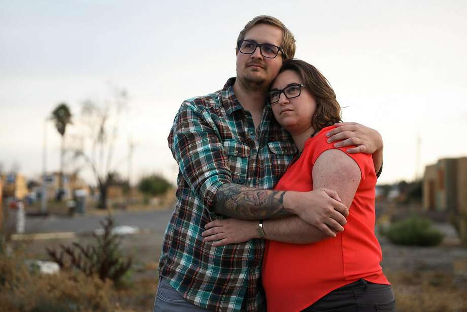 Husband and wife Cole Geissinger and Melissa Geissinger embrace as they stand for a portrait at the site of their destroyed home after the Tubbs Fire tore through it last year in Santa Rosa, California, on Thursday, Sept. 27, 2018. Photo: Gabrielle Lurie / The Chronicle