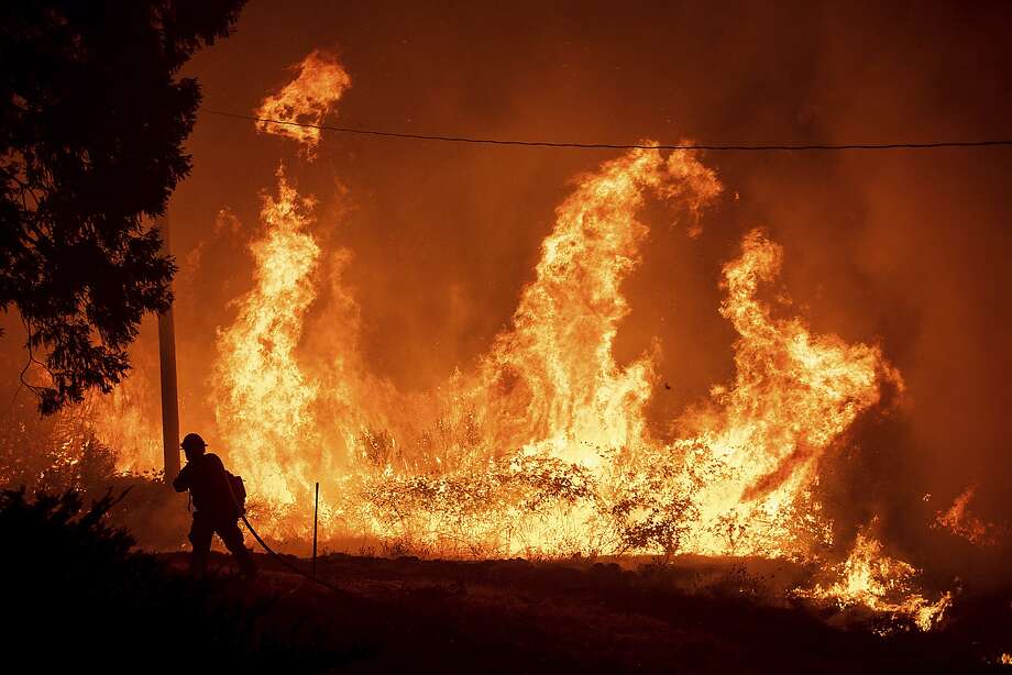 A firefighter passes flames from a backfire while battling the Delta Fire in the Shasta-Trinity National Forest, Calif., Thursday, Sept. 6, 2018. (AP Photo/Noah Berger) Photo: Noah Berger / Associated Press