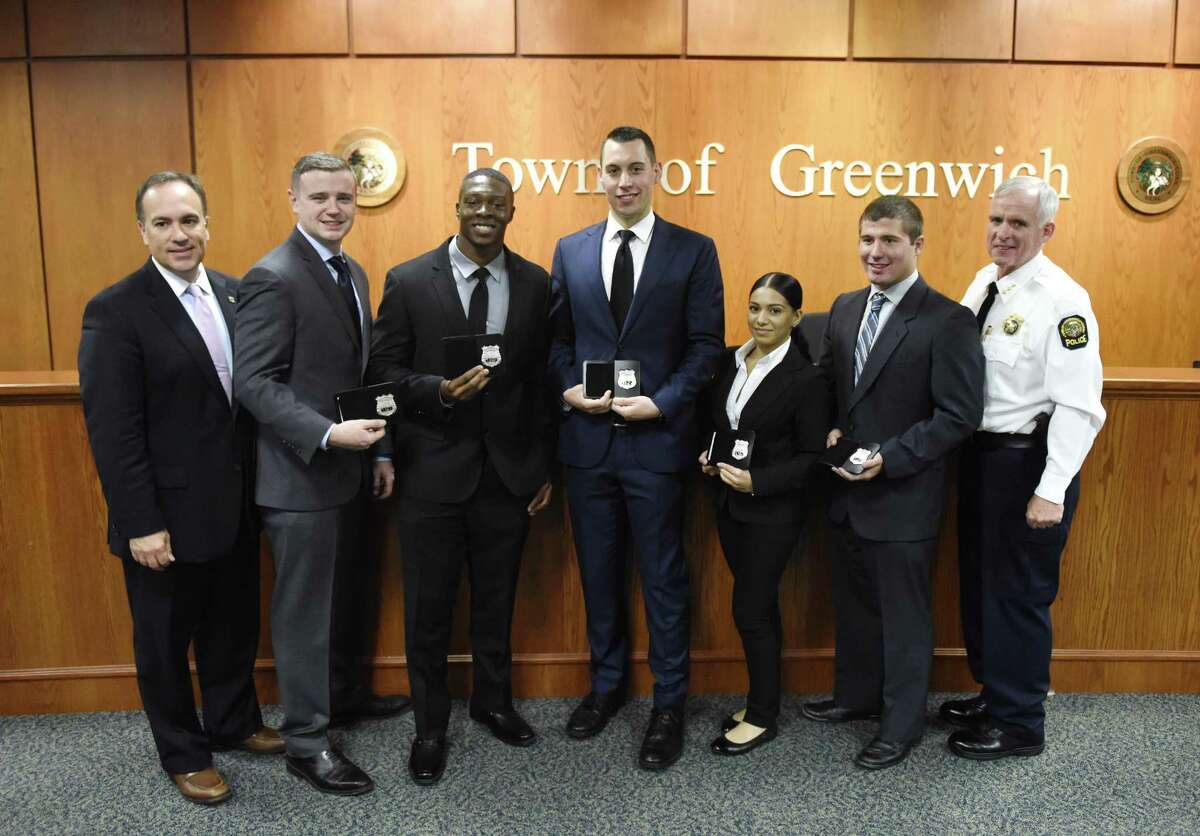 Police Commissioner and First Selectman Peter Tesei, far left, and Chief of Police James Heavey, far right, pose with new police recruits, from left, Kevin Ingraham, Allen Arrington, William O'Connor, Erica Rosario, and Christopher Manjuck at the swearing-in ceremony for new Greenwich police officers at Town Hall in Greenwich on Monday. Five new police recruits, Allen Arrington, Kevin Ingraham, Christopher Manjuck, William O'Connor and Erica Rosario, were sworn in on Monday.