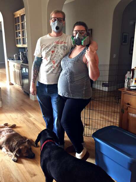Cole and Melissa Geissinger wear gas masks to protect themselves from the smoke as the wildfires continue to burn. Photo: Courtesy Geissinger Family 2017