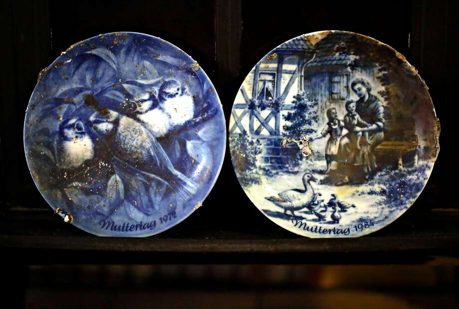 Decorative plates that survived the Tubbs Fire in the Oakland apartment where Henry and Astrid Granger stayed following the loss of their home. Photo: Guy Wathen / The Chronicle