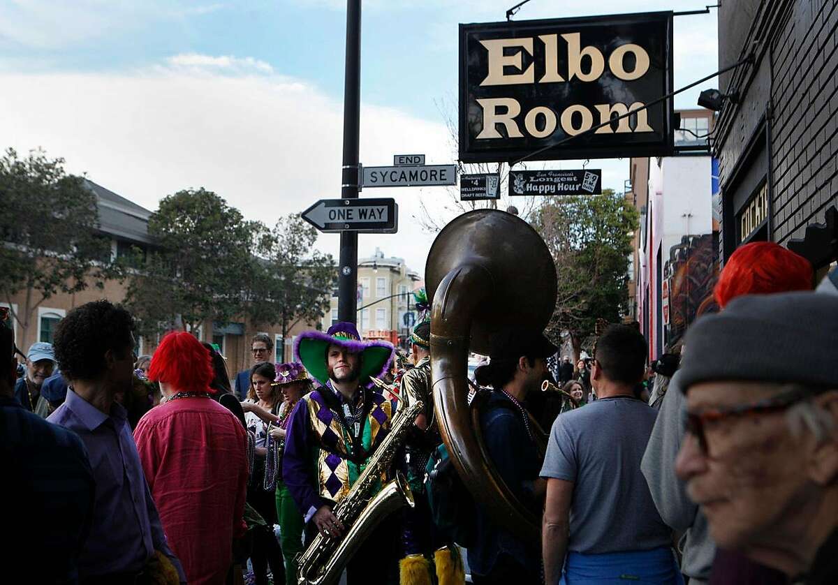 Monk Funkster stands outside the Elbo Room with fellow musicians preparing to start the fifth annual Fat Tuesday parade through the Mission district in San Francisco, Calif., on Tuesday Feb. 9, 2016