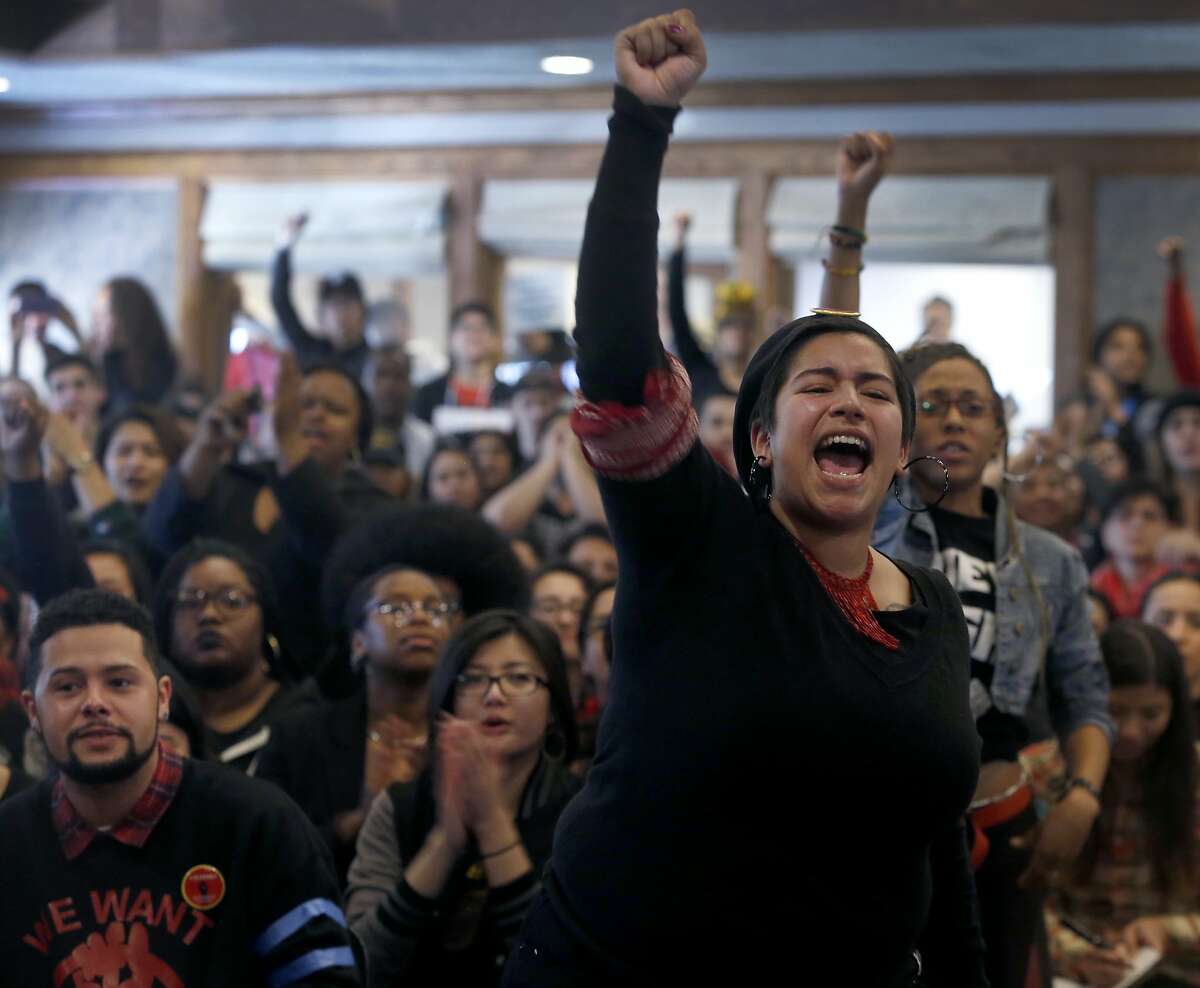 Yesenia Mendez and other students from the College of Ethnic Studies rise up during a contentious meeting with San Francisco State University President Les Wong and other administrators in San Francisco, Calif. on Thursday, Feb. 25, 2016.