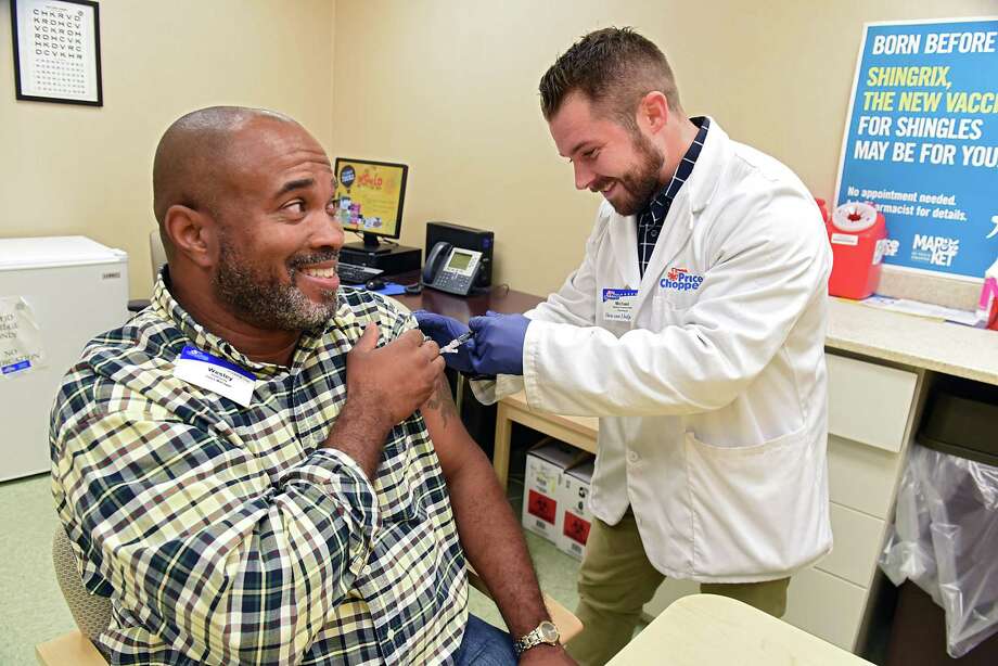 Price Chopper store manager Wesley Holloway gets a flu shot from Price Chopper pharmacist Mike Barkley on Tuesday, Oct. 2, 2018 in Loudonville, N.Y. (Lori Van Buren/Times Union) Photo: Lori Van Buren, Albany Times Union / 20045016A