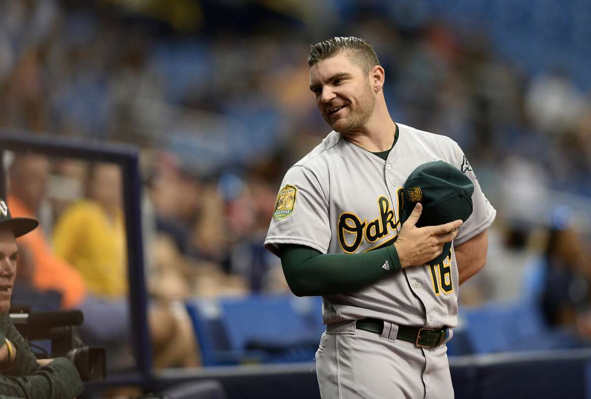 Oakland Athletics Liam Hendriks (16) stays on the field following the National Anthem during a baseball game against the Tampa Bay Rays Sunday, Sept. 16, 2018, in St. Petersburg, Fla. (AP Photo/Jason Behnken)