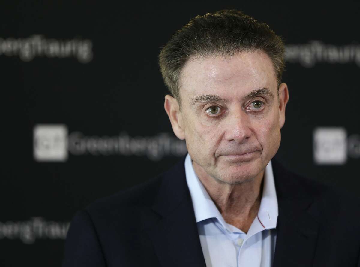 FILE- In this Feb. 21, 2018 file photo, former Louisville basketball Hall of Fame coach Rick Pitino talks to reporters during a news conference in New York. A recruiter, a coach and a former Adidas executive are scheduled to go on trial in New York in a criminal case that exposed corruption in several top U.S. college basketball programs. It also led to the firing of Pitino and sidelined the playing career of standout recruit Brian Bowen Jr. (AP Photo/Seth Wenig, File)