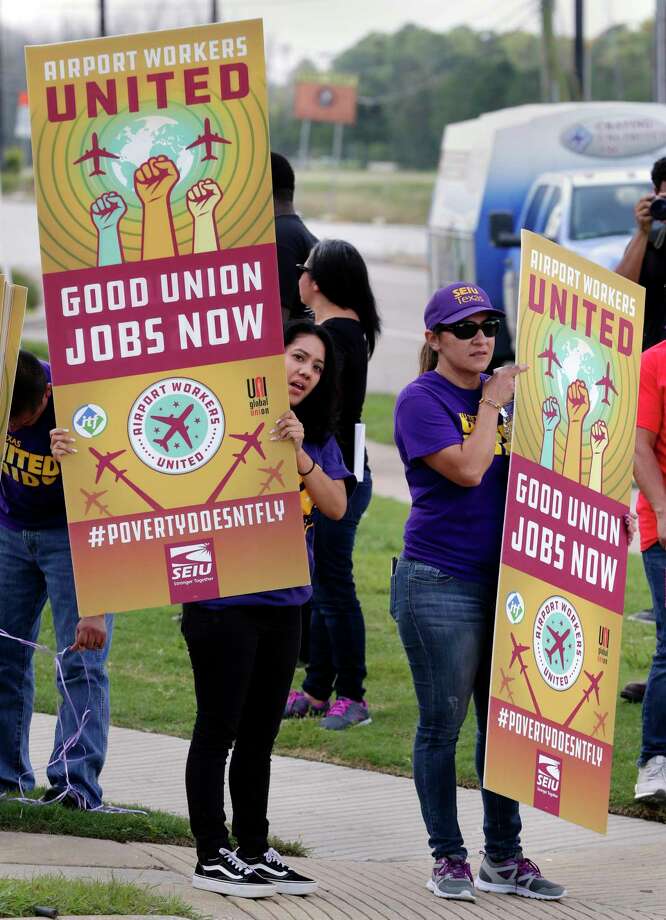 nancy hernandez and cathy martinez wave posters as they protest