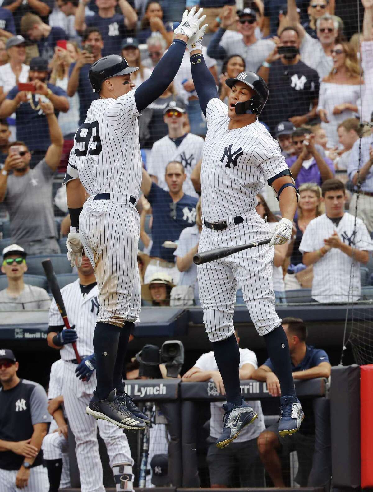 NEW YORK, NY - JULY 21: Aaron Judge #99 of the New York Yankees celebrates with teammate Giancarlo Stanton at the dugout after he hit a home run in the seventh inning during an interleague MLB baseball game against the New York Mets on July 21, 2018 at Yankee Stadium in the Bronx borough of New York City. Yankees won 7-6. (Photo by Paul Bereswill/Getty Images)