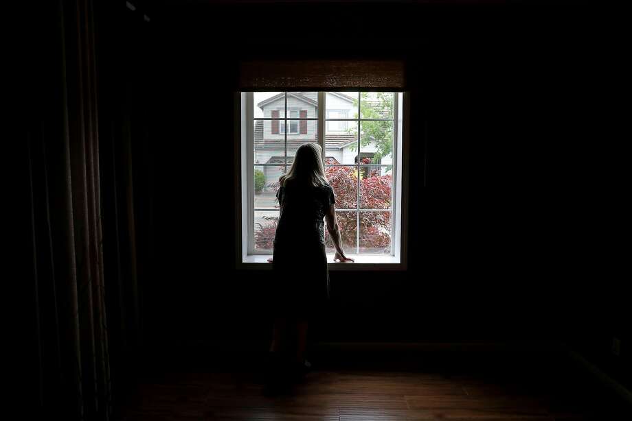 Astrid Granger peers through the window of her new home in Windsor on Friday, July 6, 2018. More than 8 months after the Tubbs Fire destroyed their home in Santa Rosa, the Grangers finally have a home of their own. Photo: Guy Wathen / The Chronicle