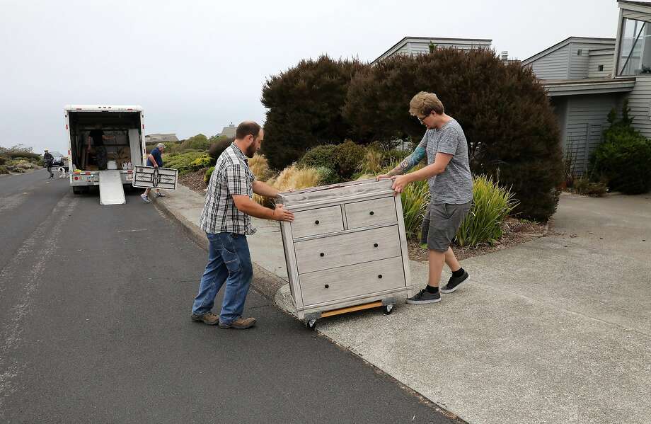 Kenny Crain, left, helps his brother-in-law Cole Geissinger move into a Bodega Bay rental home on Sunday, August 19, 2018. Photo: Guy Wathen / The Chronicle