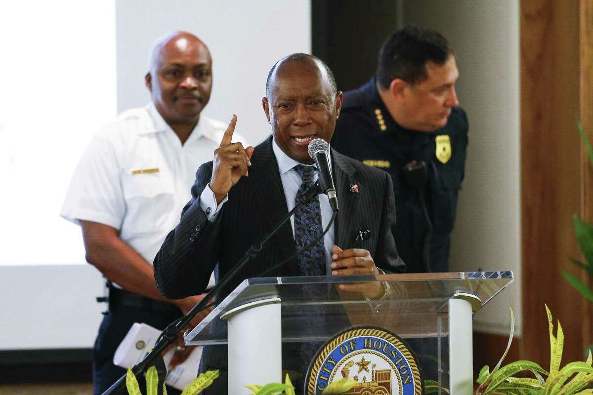 Houston mayor Sylvester Turner, center, stands at the podium as he holds a town hall with Houston Fire Department executive assistant chief Rodney West, left, and Houston Police chief Art Acevedo, right, in a collective attempt to convince the public to vote against a pay parity ballot measured for the Houston Fire Department Wednesday Sept. 19, 2018 in Houston.