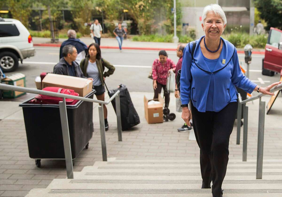 UC Berkeley Chancellor Carol Christ walks through the Unit 1 Residential Hall while greeting new students and parents during move-in day in Berkeley, Calif. Tuesday, Aug. 14, 2018.