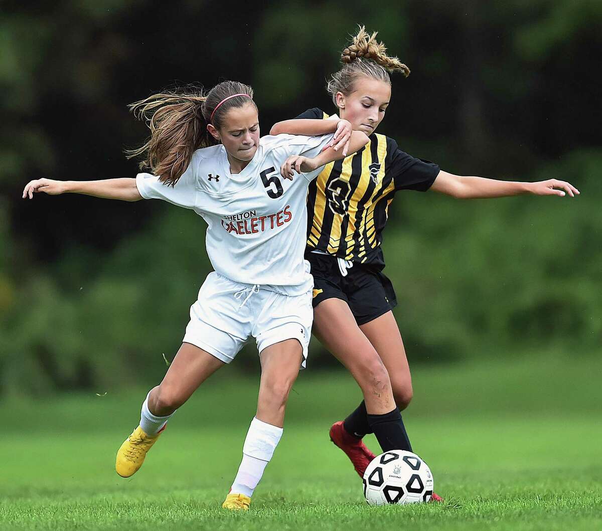 Shelton’s Elizabeth Porto wins control of the ball as Amity’s Martyna Krzysztopik defends on Tuesday. Shelton won, 3-0, and remain undefeated at 7-0.