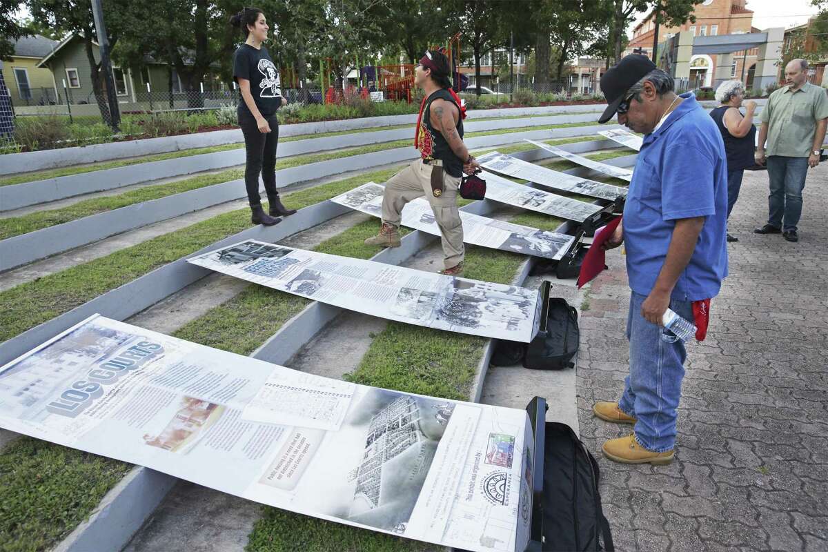 Santiago Ramirez looks over displays depicting the history of the Alazan-Apache Courts as the San Antonio Housing Authority hosts a National Night Out event at Guadalupe Plaza on October 2,, 2018.