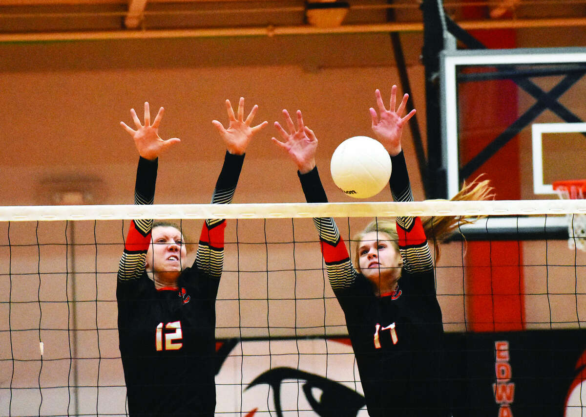 Edwardsville’s Morgan Tulacro, left, and Storm Suhre go up for a successful block during Tuesday’s match against O’Fallon at Lucco-Jackson Gymnasium.
