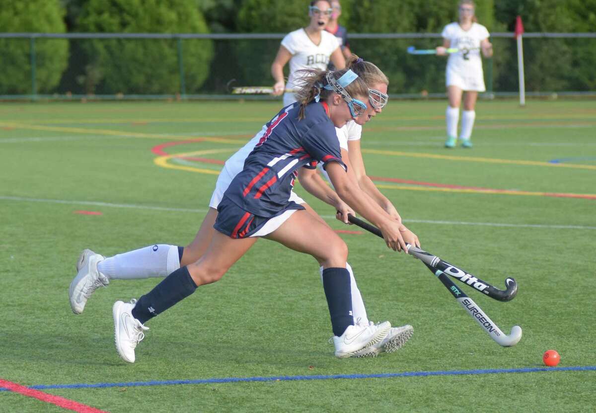 Greens Farms Academy field hockey player Keely O'Shea, a resident of Darien, races a Rye Country Day opponent to the ball during a game last week in Westport.