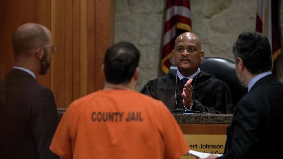 Judge Robert Johnson speaks with Blaine Boudreaux, who was sentenced to 80 years for felony murder after killing two people in separate accidents in April 2015, after hearing victim impact statements in the 177th state District Court, Wednesday, Oct. 3, 2018, in Houston.