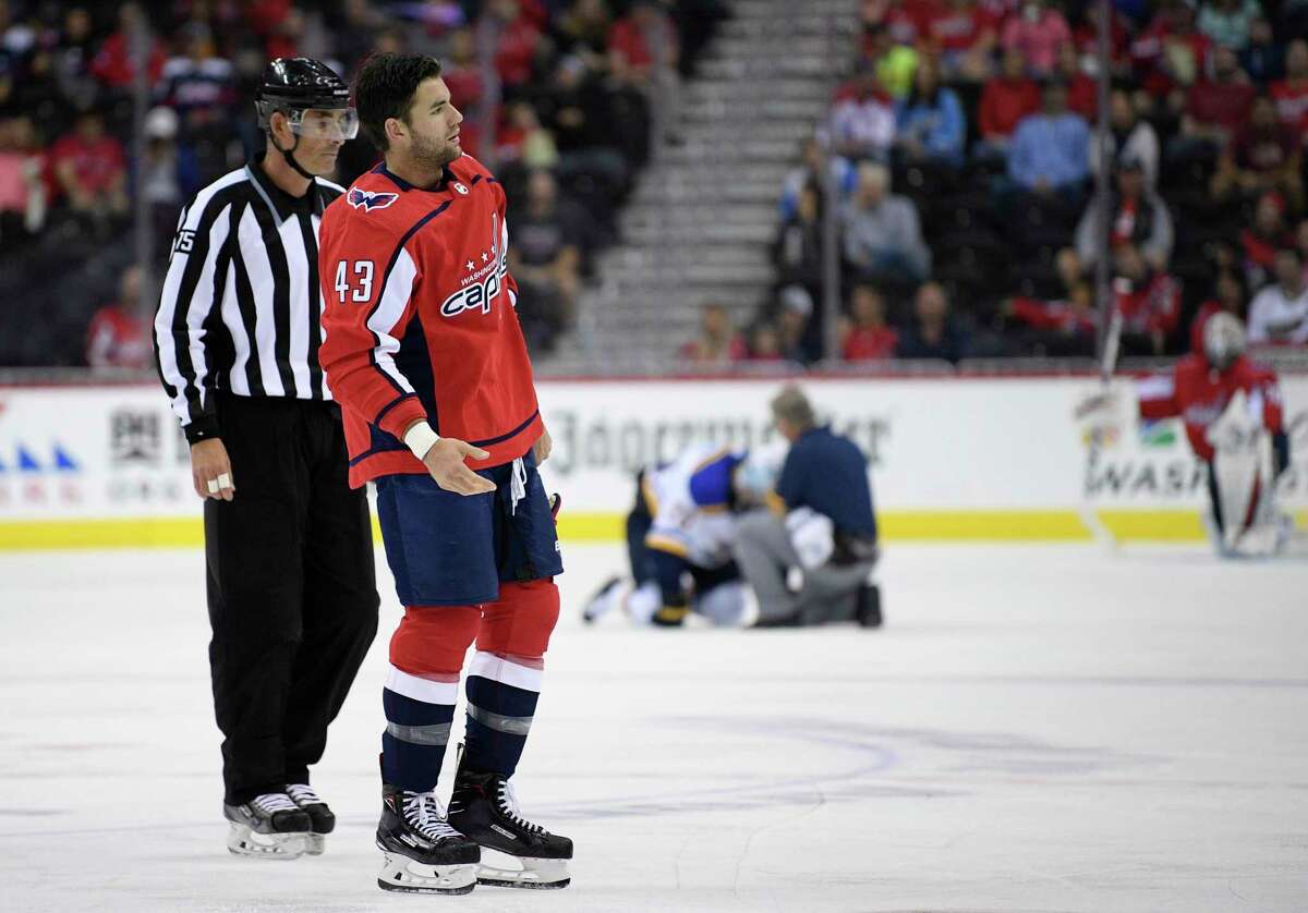 Washington Capitals right wing Tom Wilson (43) is escorted by an official off the ice after he checked St. Louis Blues center Oskar Sundqvist, on ice at back center, during the second period of an NHL preseason hockey game, Sunday, Sept. 30, 2018, in Washington. (AP Photo/Nick Wass)
