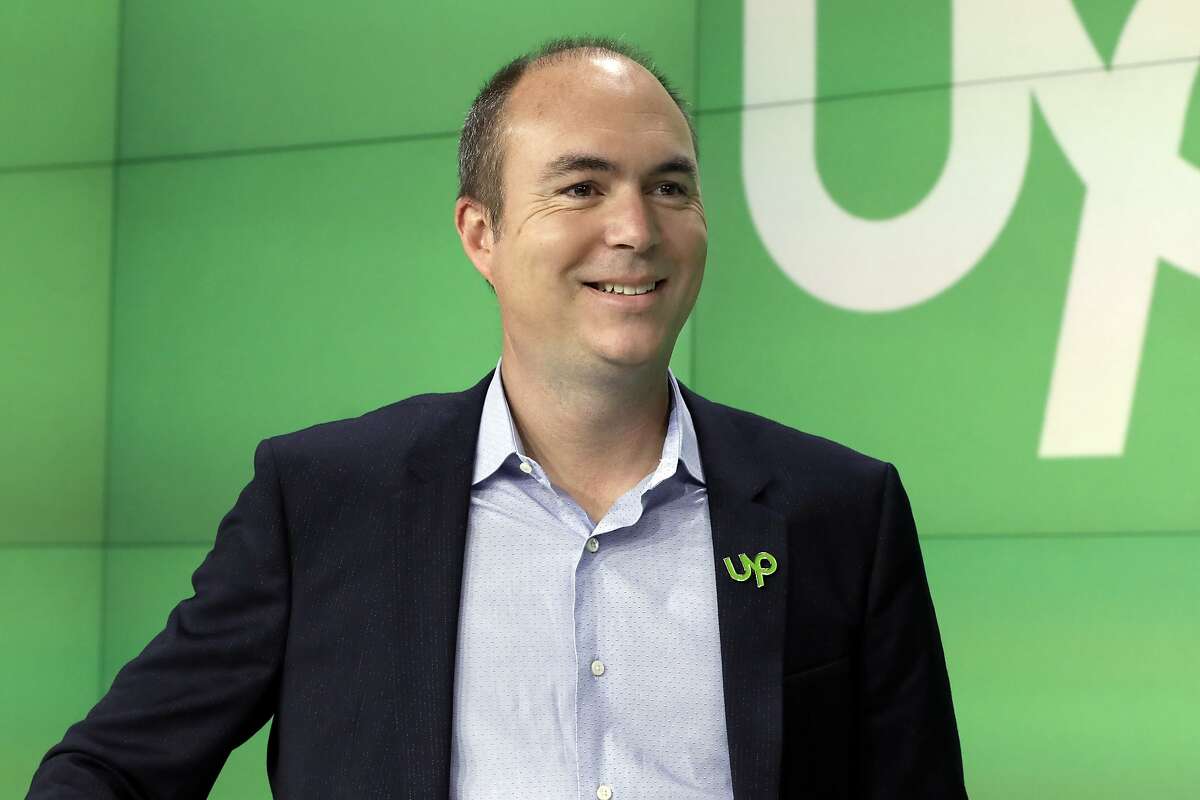 Upwork Inc. President & CEO Stephane Kasriel poses for photos before his company's IPO begins trading at the Nasdaq MarketSite, in New York's Times Square, Wednesday, Oct. 3, 2018. (AP Photo/Richard Drew)