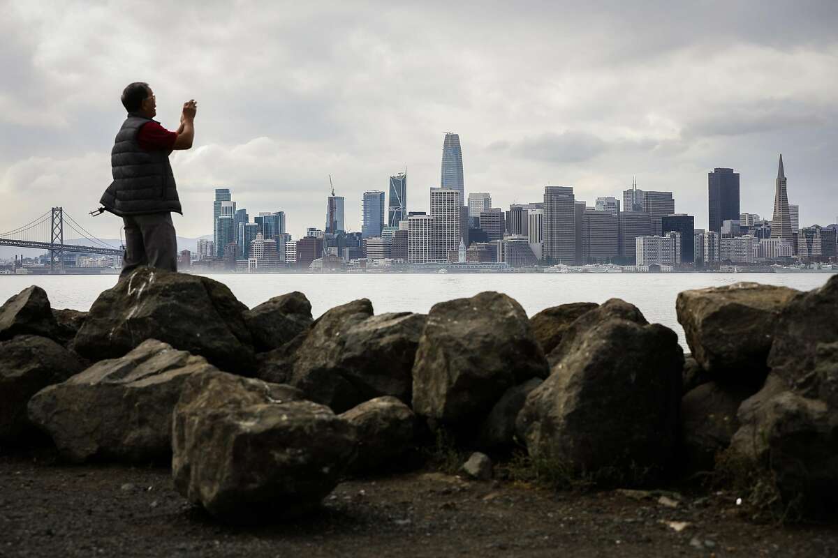 Liem Phan of Oakland takes a photo of the skyline from Treasure Island in San Francisco, California, on Wednesday, Oct. 3, 2018.
