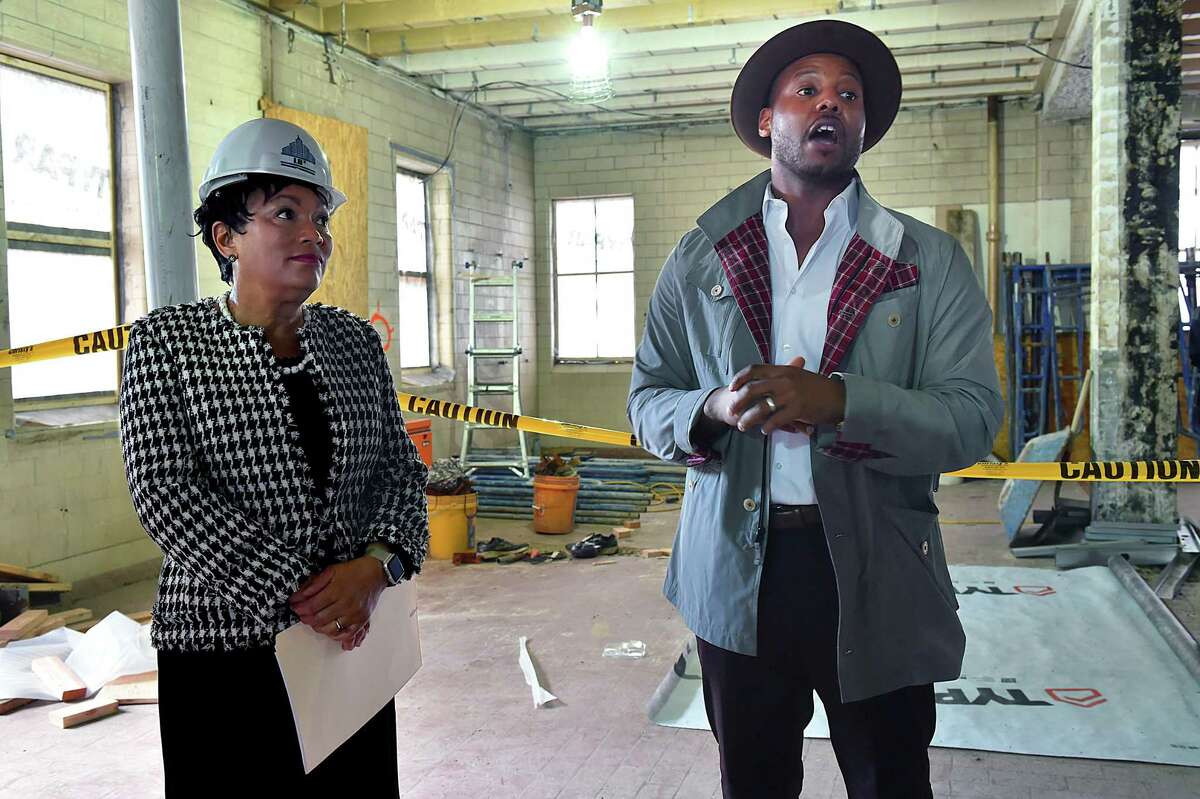 Titus Kaphar, artist and co-founder of NXTHVN, a sustainable creative art space at 169 Henry St. in New Haven, gives a tour of the former manufacturing plant to Mayor Toni N. Harp and others Wednesday.
