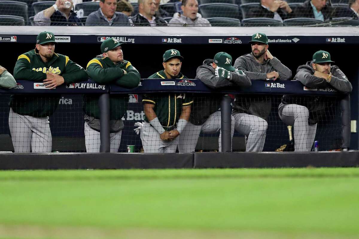The Oakland Athletics bench reacts during the ninth inning against the New York Yankees in the American League Wild Card Game at Yankee Stadium on October 03, 2018 in the Bronx borough of New York City.