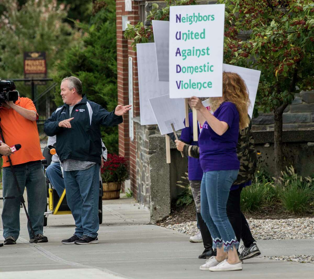 Cohoes Mayor Shawn Morse, left, addresses protestors against domestic violence as they voice their feelings in front of Cohoes City Hall Thursday Oct.4, 2018 in Cohoes, N.Y. (Skip Dickstein/Times Union)