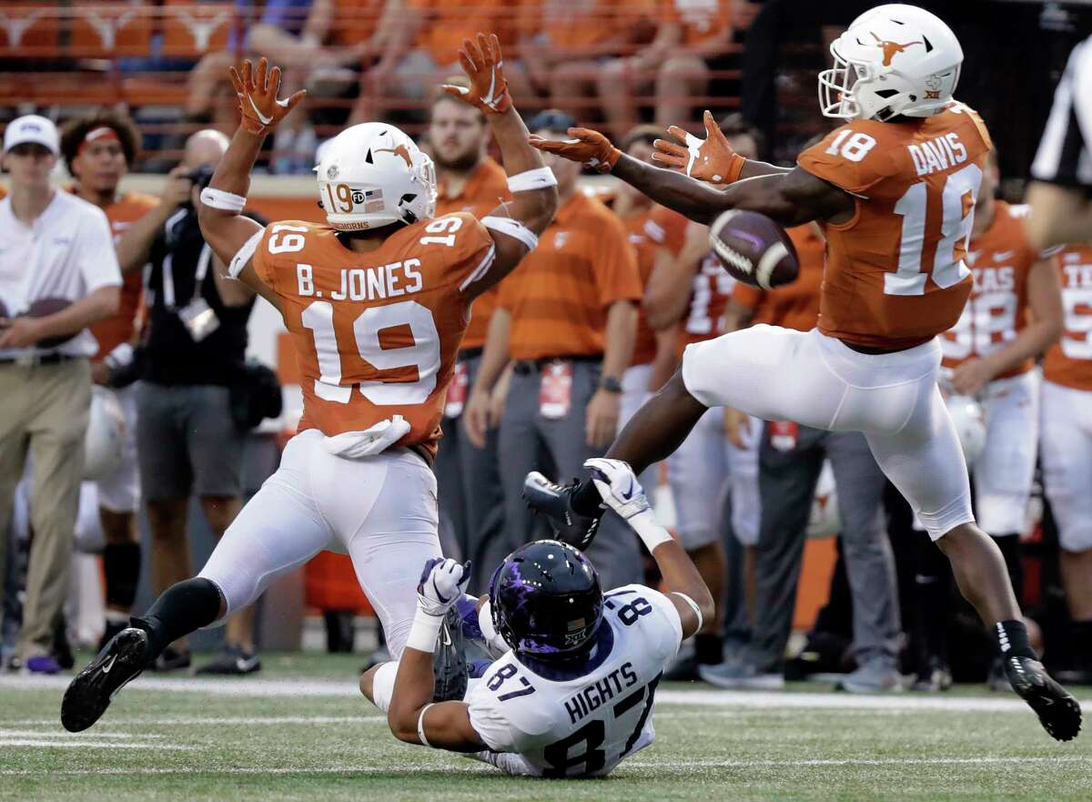 Texas defensive back Brandon Jones (19) an d defensive back Davante Davis (18) break up a pass intended for TCU wide receiver TreVontae Hights (87) during the second half of an NCAA college football game, Saturday, Sept. 22, 2018, in Austin, Texas. (AP Photo/Eric Gay)