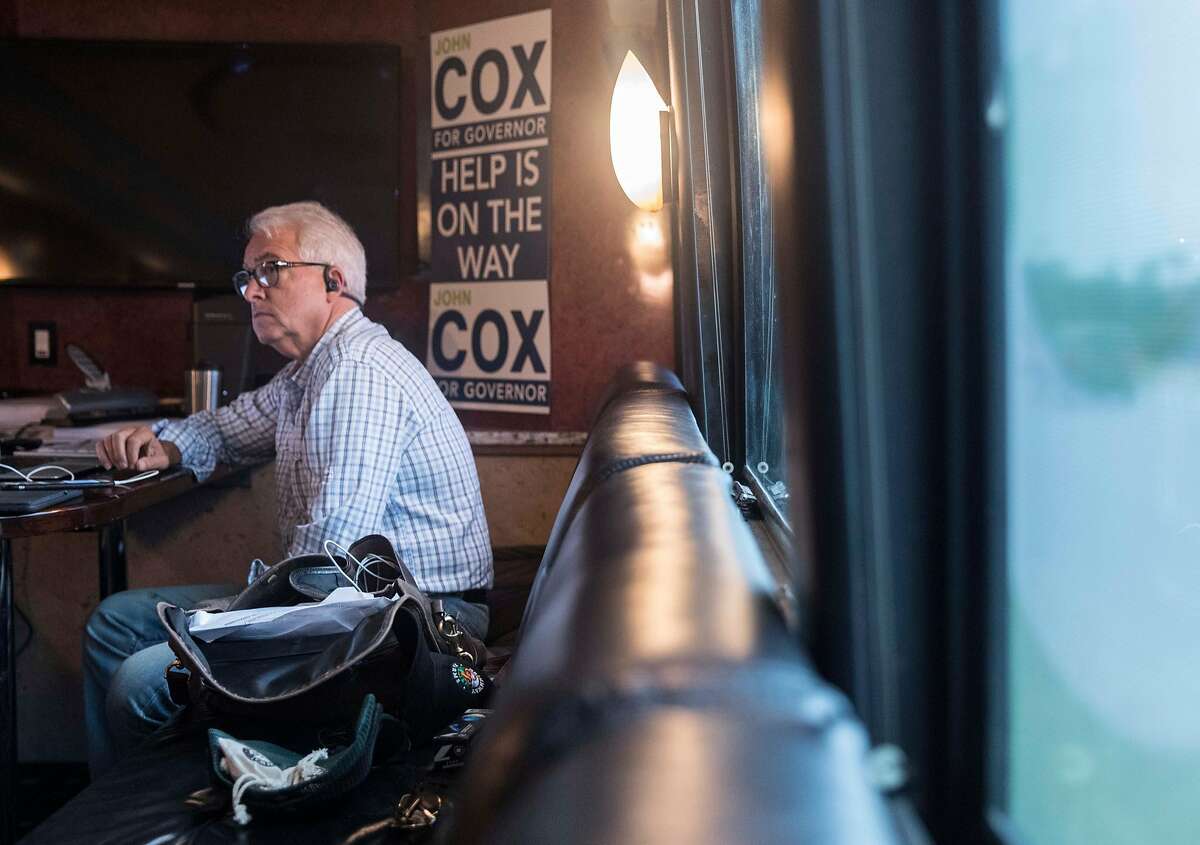 Republican Governor candidate John Cox works on his computer while riding on his campaign bus during a state-wide tour through California Friday, Sept. 28, 2018.