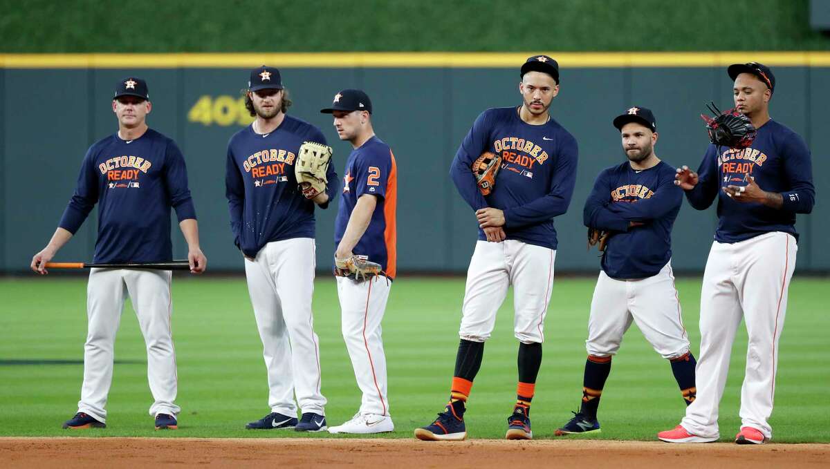 Houston Astros manager AJ Hinch, pitcher Gerrit Cole, Alex Bregman, Carlos Correa, Jose Altuve, and catcher Martin Maldonado watch from the infield during batting practice at Minute Maid Park, October 4, 2018, in Houston.