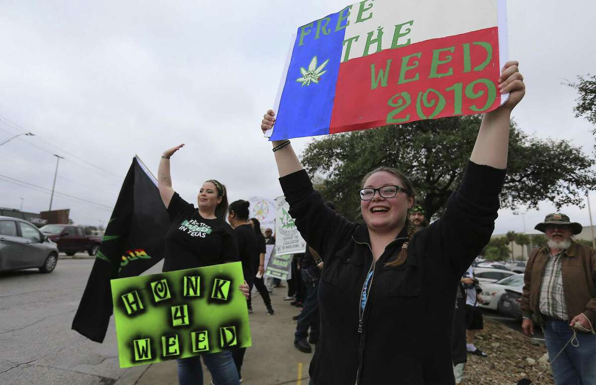 Dani Traeger (right) joins a crowd in favor of the legalization of cannabis in Texas gathered to rally at the intersection of San Pedro and Rector on Saturday, Feb. 10, 2018. The organization 420OpenCarry held the event to support the open use of recreational marijuana. (Kin Man Hui/San Antonio Express-News)