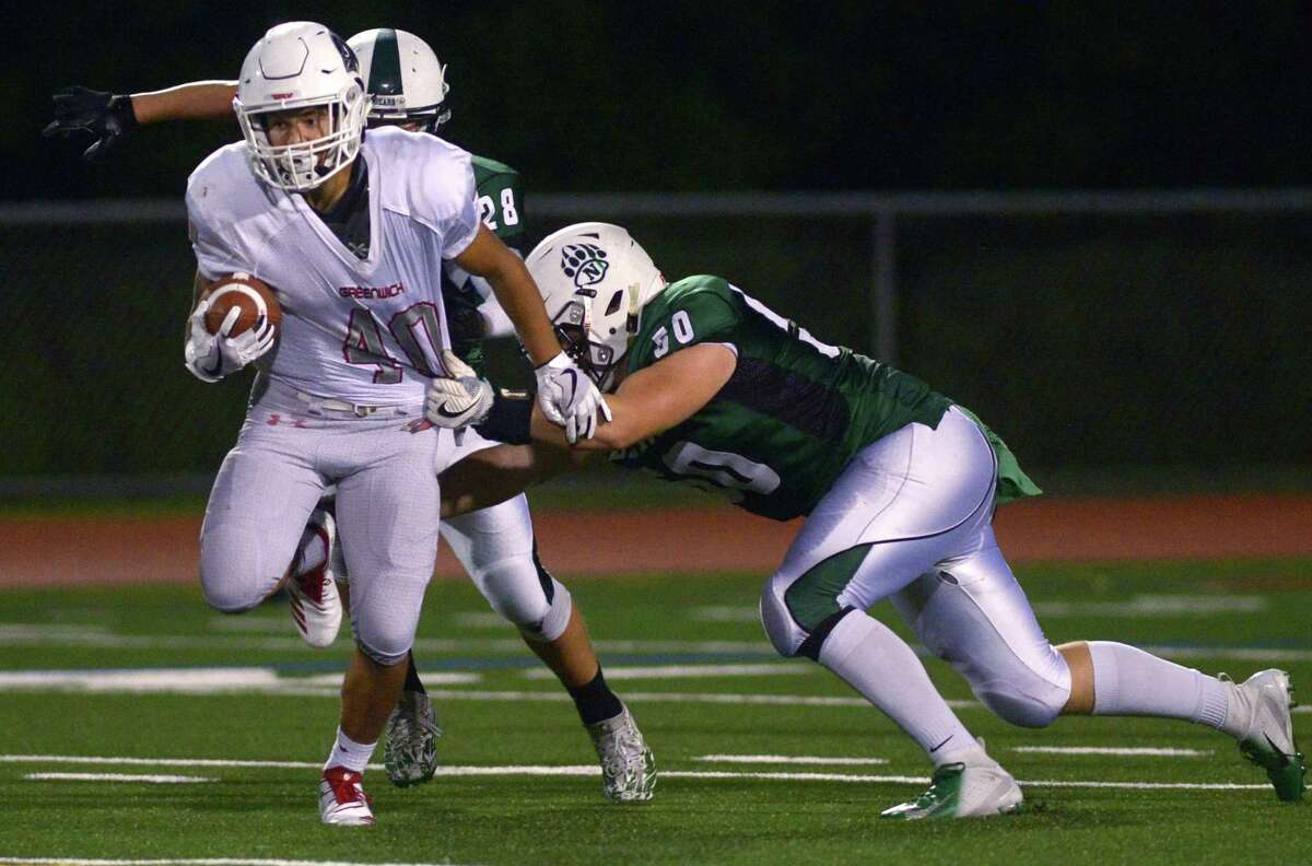 Greenwich running back Tysen Comizio attempts to break loose from a Norwalk defender on Sept. 27.