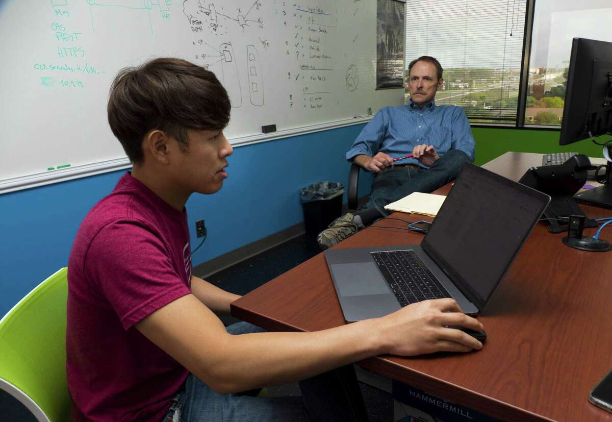 Lai Hyung, left, and Doug Hall work at SecureLogix on Tuesday, Oct. 2, 2018. The corporation works to secure voice networks.