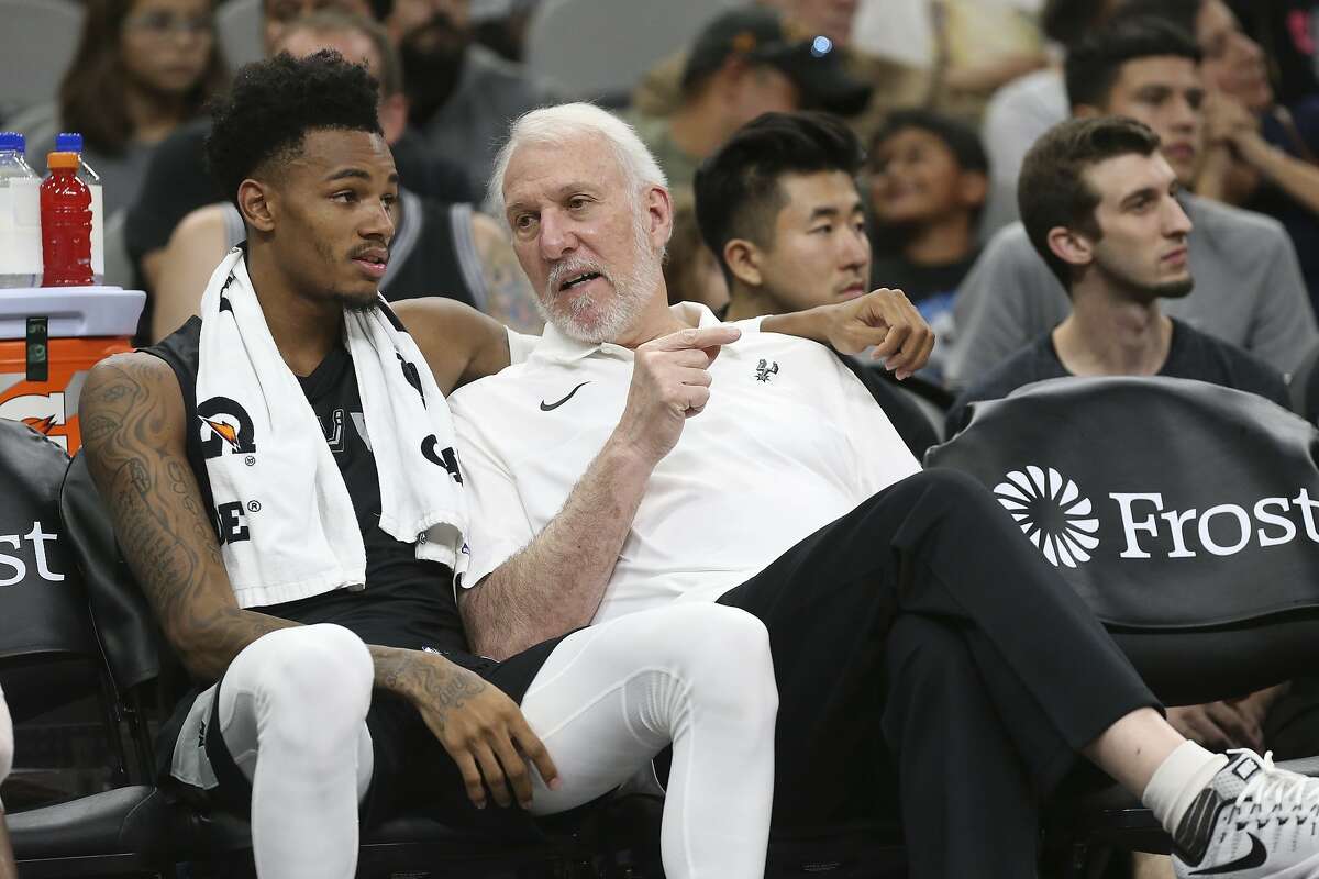 San Antonio Spurs’ head coach Gregg Popovich talks with Dejounte Murray during the Silver & Black Open Scrimmage at the AT&T Center, Wednesday, Oct. 3, 2018.