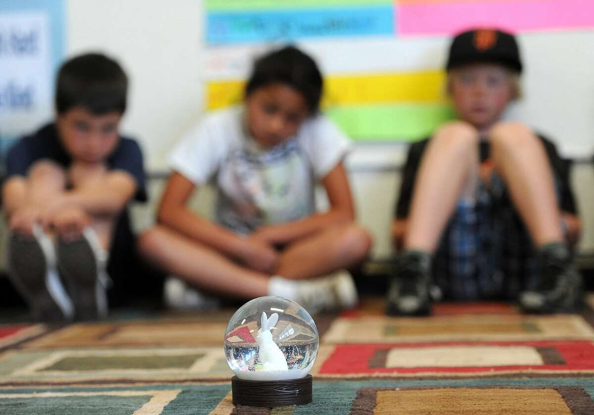Children concentrate on snowflakes falling in a snowglobe during a class on mindfulness at the Bolinas School in Bolinas on March 22, 2013. The class is part of an anti-bullying program other schools across the Bay Area have adopted in the past year and is meant to teach students mindfulness or empathy for their classmates.