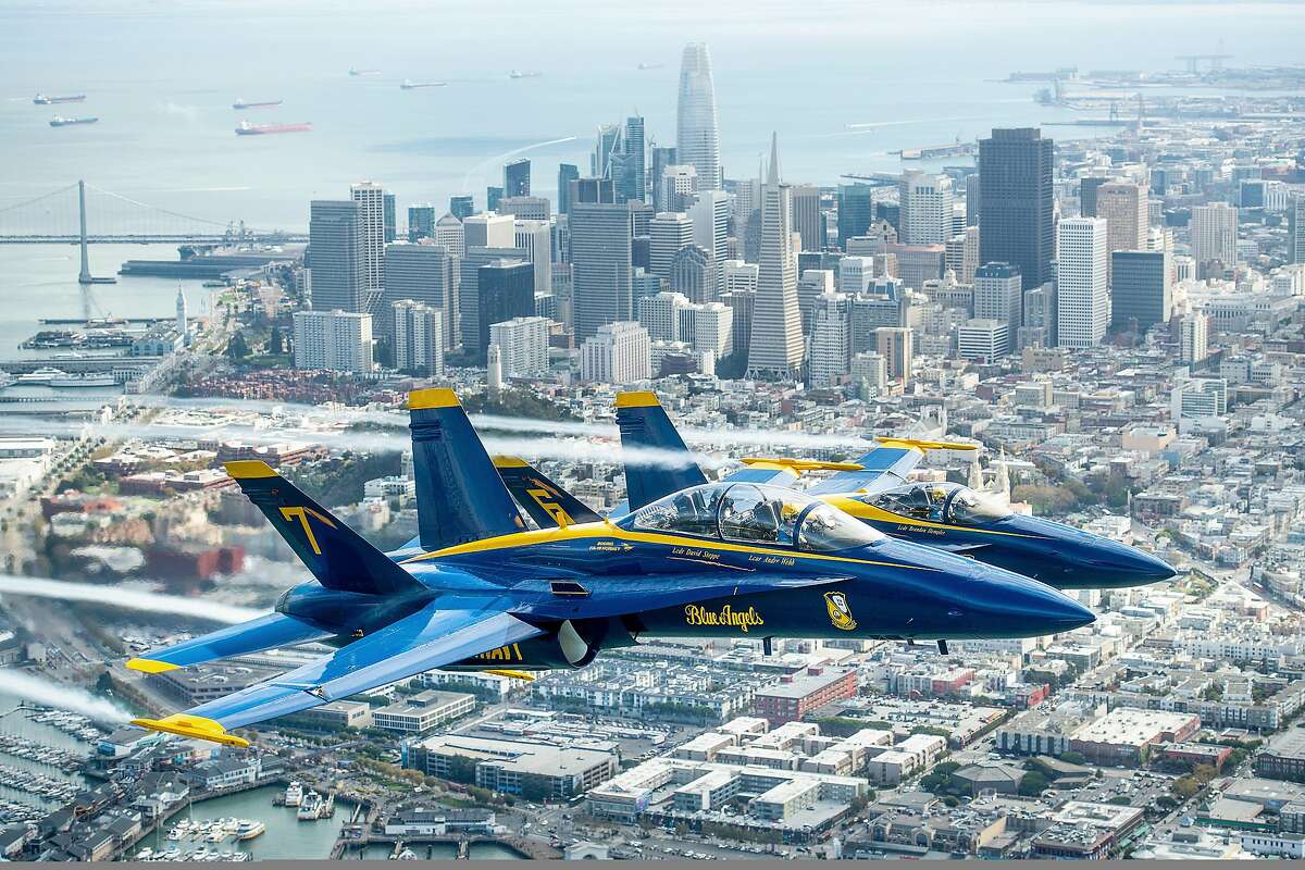 In advance of Fleet Week performances, the U.S. Navy Blue Angels and Team Oracle aerobatics pilot Sean D. Tucker fly over the San Francisco Bay during a photo flight on Thursday, Oct. 4, 2018. (AP Photo/Noah Berger)