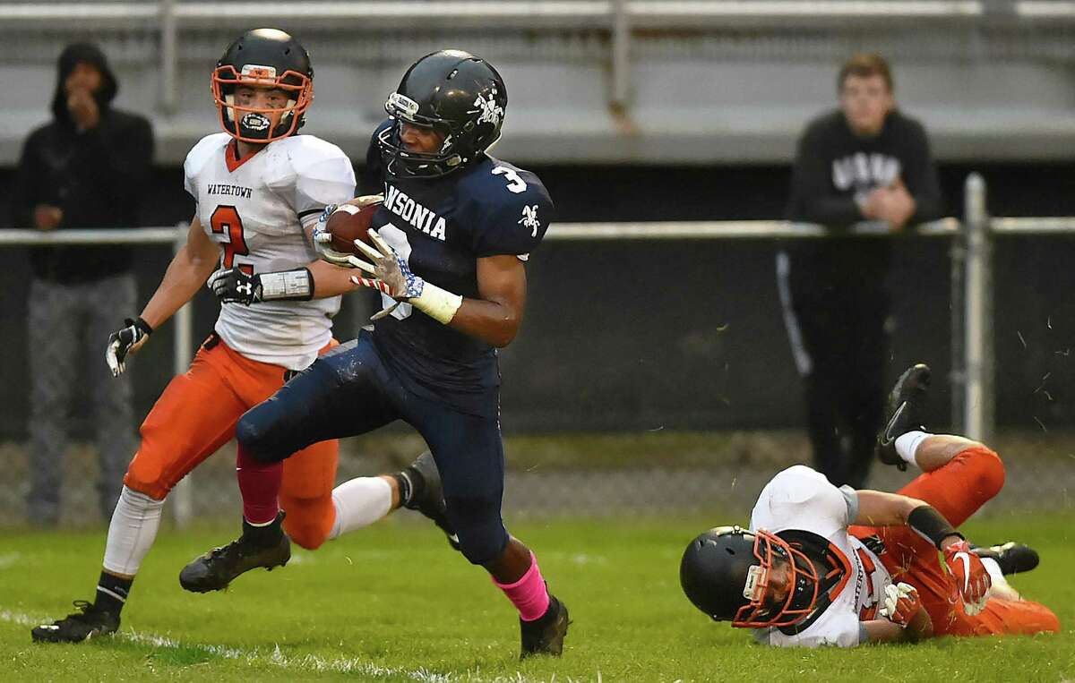 Ansonia’s Shykeem Harmon avoids a tackle attempt by Watertown’s Rich Ojeda Thursday at Jarvis Stadium in Ansonia.