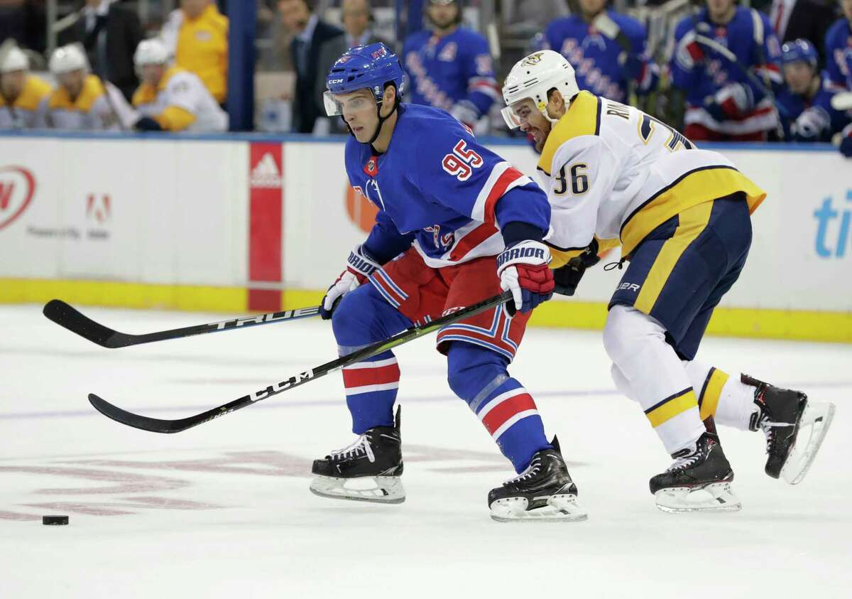 New York Rangers' Vinni Lettieri (95) fights for control of the puck with Nashville Predators' Zac Rinaldo (36) during the first period of an NHL hockey game Thursday, Oct. 4, 2018, in New York. (AP Photo/Frank Franklin II)