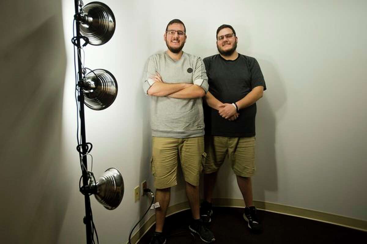 Nicholas, left, and Christopher Pilon, right, pose for a portrait inside their studio in Midland on Sept. 25. The brothers have begun a kickstarter campaign to finance the production of a documentary about Michigan. (Katy Kildee/kkildee@mdn.net)