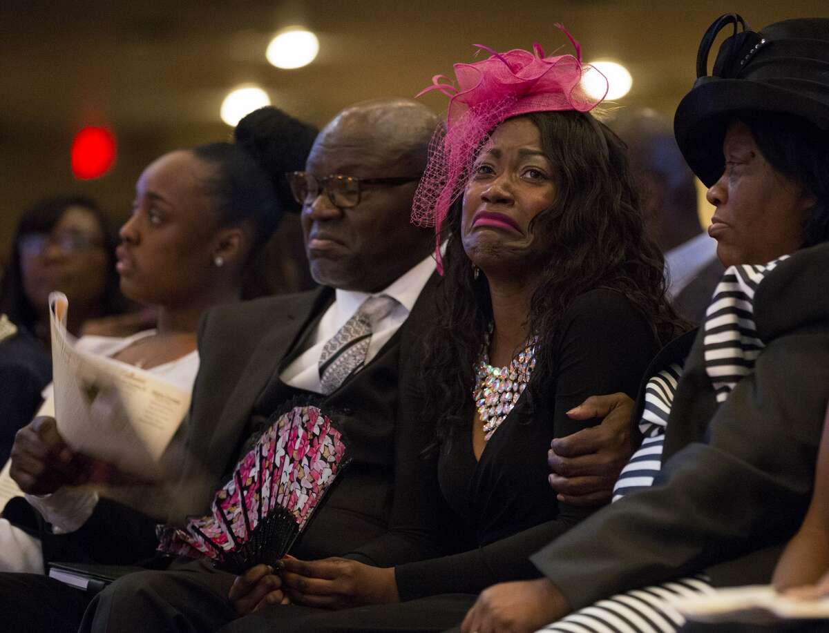 PHOTOS: Family devastated Roxane Freeman, center, grieves the loss of her husband, Heywood, and children, Halynn and Haywood Jr., during the funeral service at the Greater Grace Outreach Church. >>>See more images of the wreck's impact on a Houston family ...