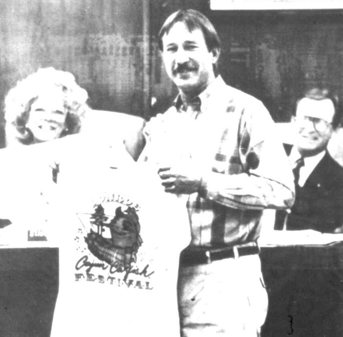 Richard Willis presents a Conroe Cajun Catfish Festival T-shirt to the Conroe City Council including Mayor Starlett Curry during the festival’s first year in 1990.