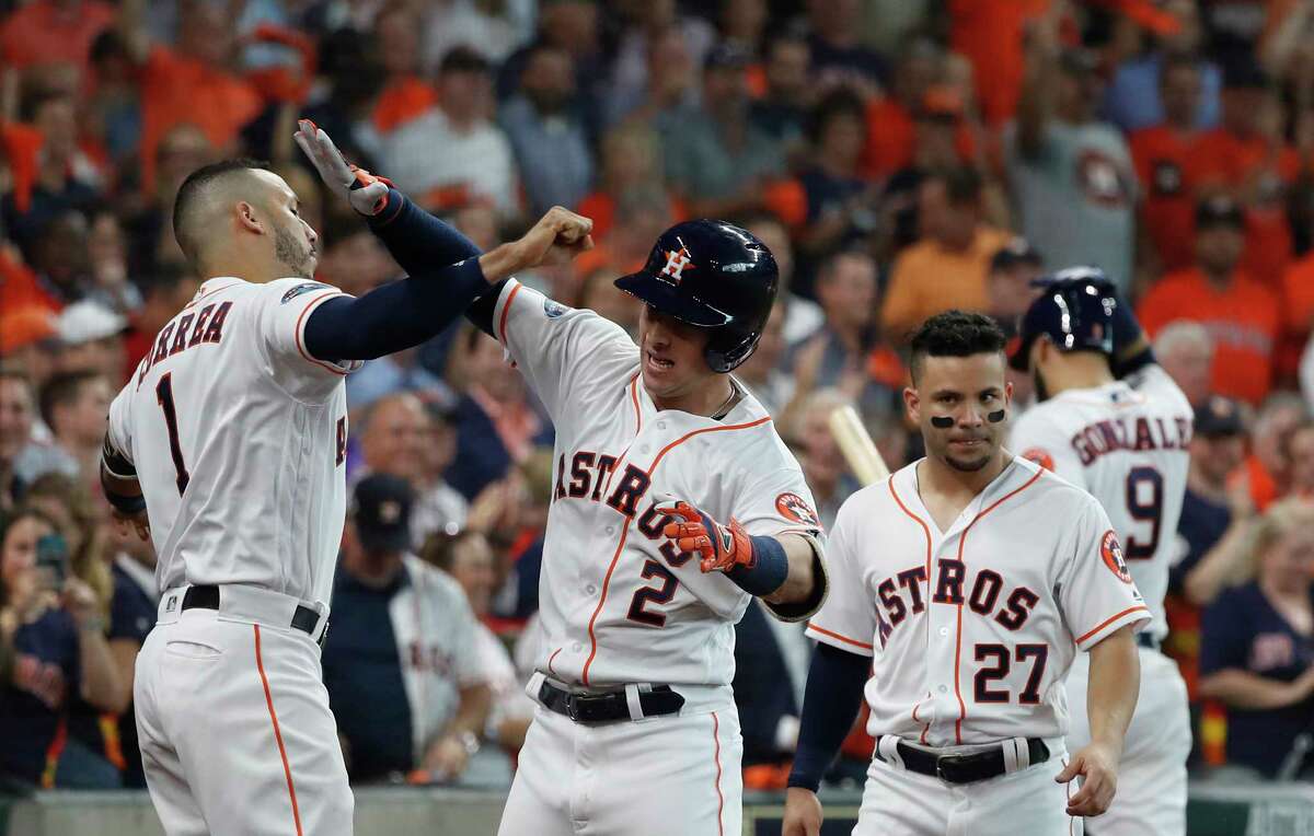 Houston Astros third baseman Alex Bregman (2) celebrates a home run with Houston Astros shortstop Carlos Correa (1) in the fourth inning of Game 1 of the American League Division Series at Minute Maid Park on Friday, Oct. 5, 2018, in Houston.